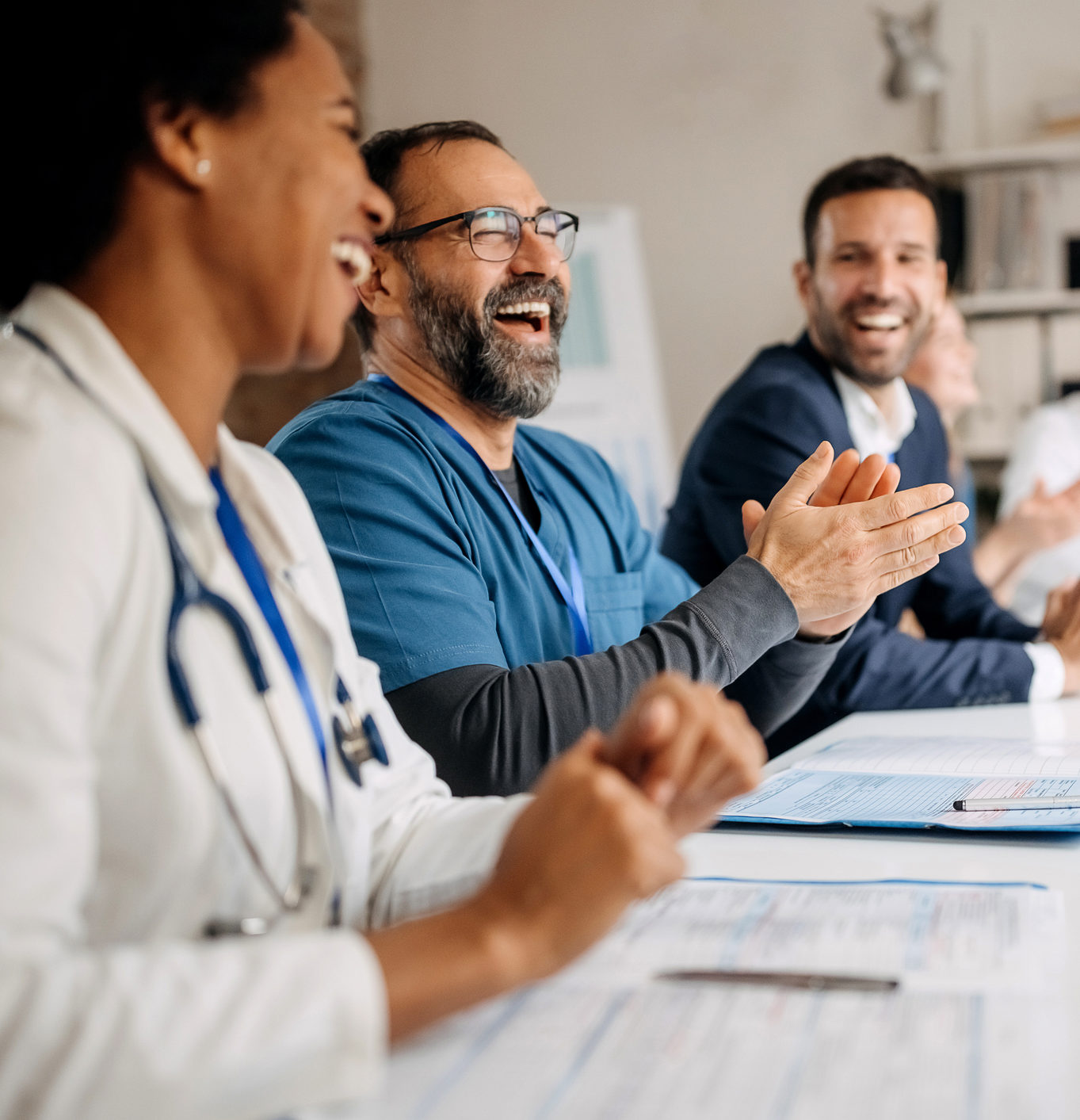 Group of doctors applauding while attending healthcare seminar