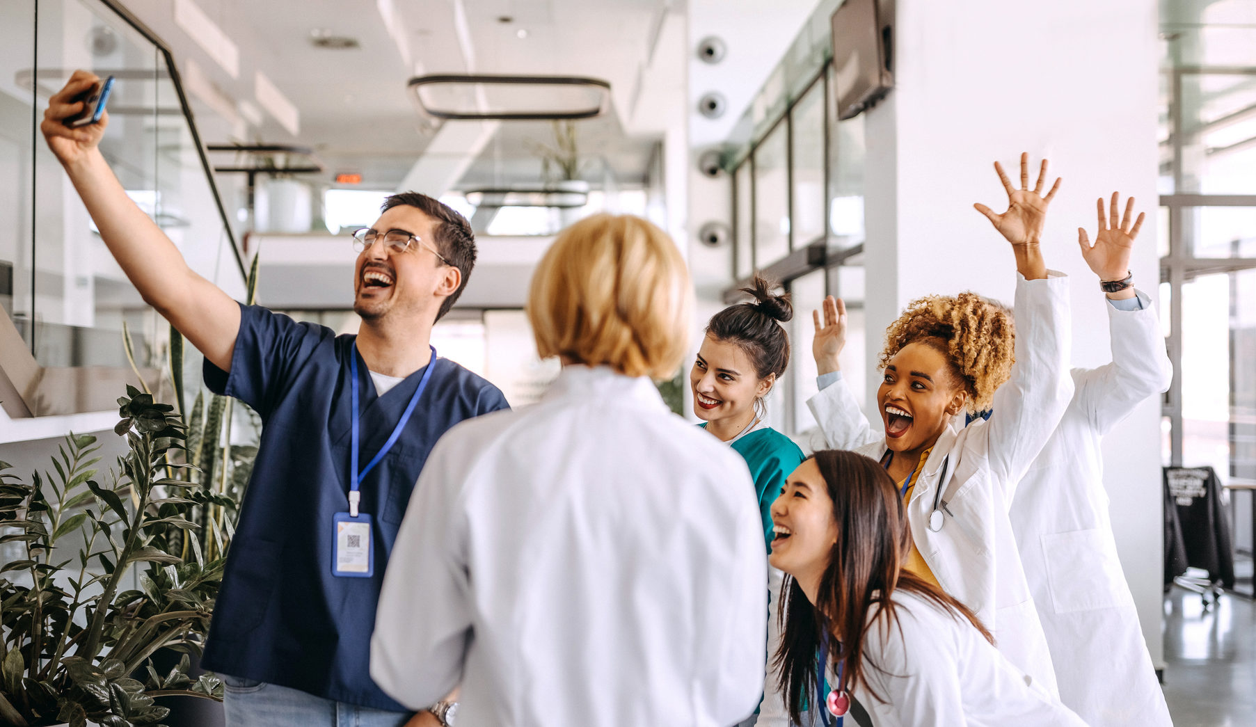 Doctors taking selfie in hospital corridor