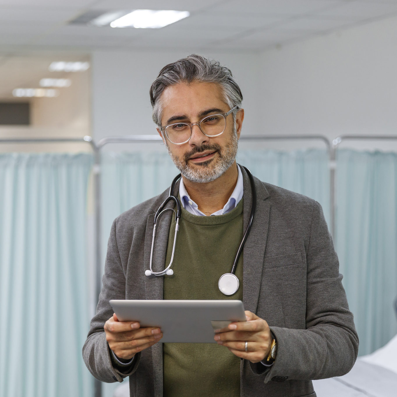 Portrait of doctor reviewing patient medical record on digital tablet