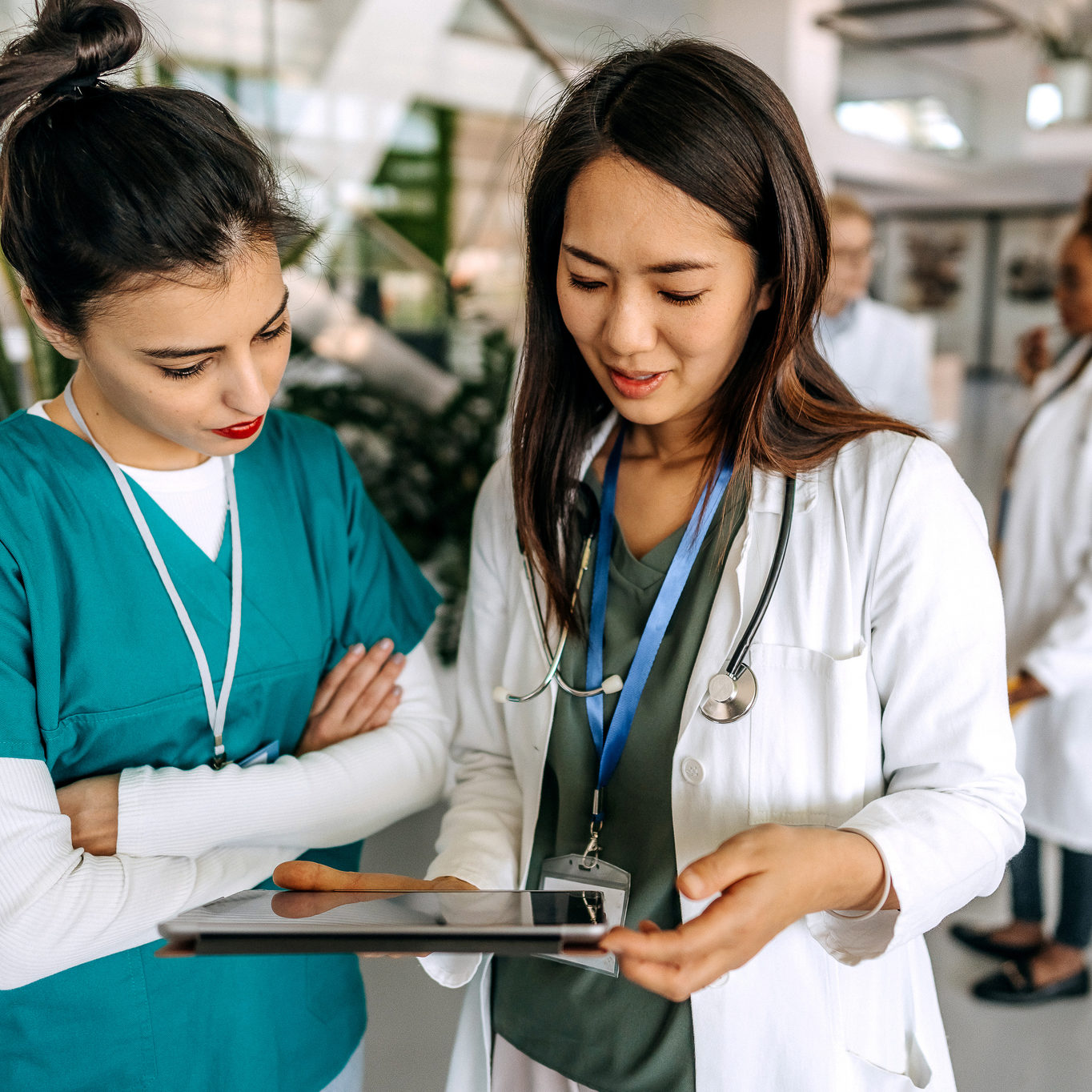 Female doctors talking in hospital corridor